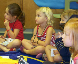 Several children sitting on the floor