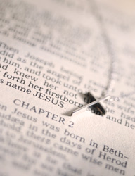 Image of an open bible with a silver cross laying in it