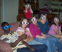 Several youth sitting down and wearing 3D movie glasses